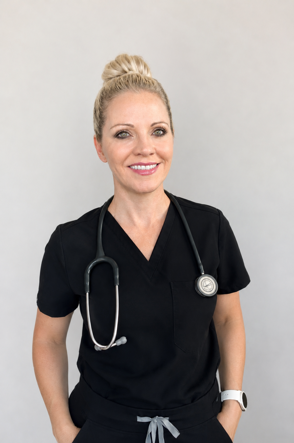 Christine, RN, in clinical scrubs with stethoscope